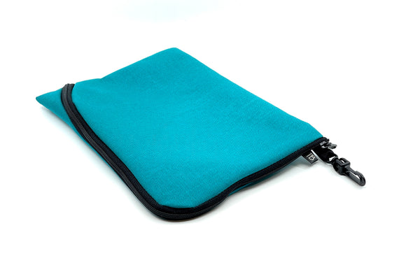 An A5 Ghost Whale Pouch in Mayura (teal).